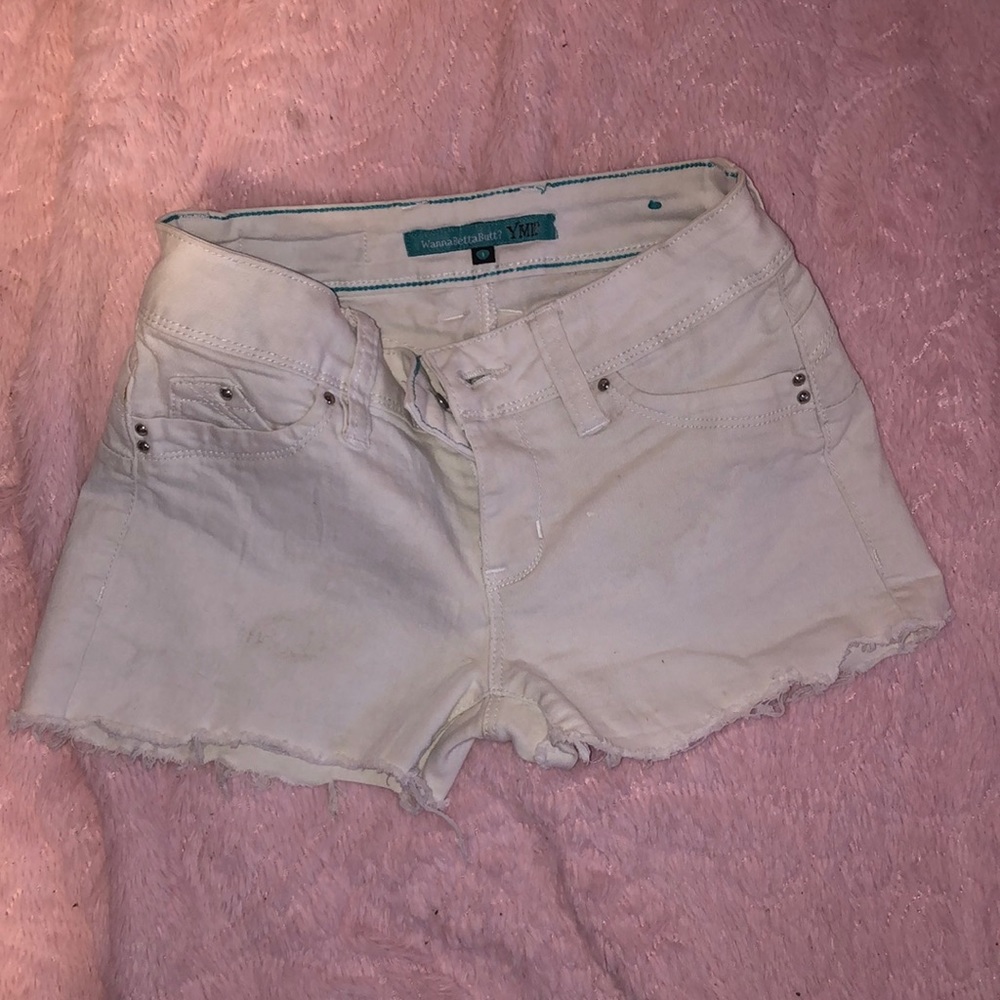white cutoff booty shorts, has rhinestone details on pockets.